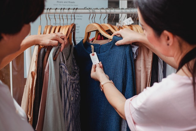 checking tags on clothes at a shop